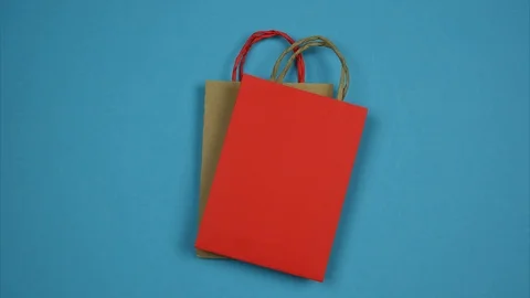 Disposable bag on a blue background replaced by a paper bag. Stop motion Video stock 124422423