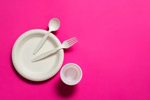Disposable biodegradable fork, spoon, glass and plate of corn starch Stock Photos