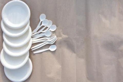 Disposable biodegradable tableware on craft paper in nature. Stock Photos