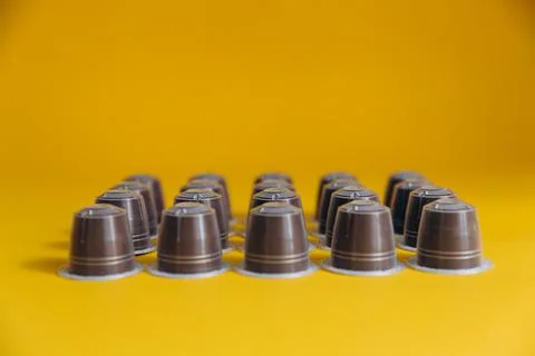 Disposable coffee capsules lying in rows Stock Photos