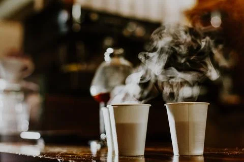 Disposable coffee cup on table Stock Photos