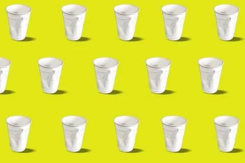 Disposable crumpled plastic glasses. Pattern on a yellow background. Stock Photos
