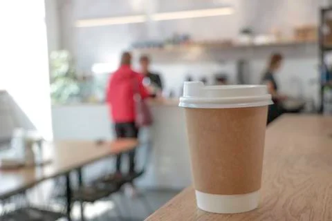 Disposable cup. Mock up with a cup of coffee. Stock Photos