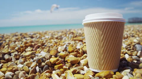 Disposable cup on a pebble beach, waste / relaxation concept Stock Footage 50727626