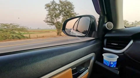 Disposable cup sitting inside the vehicle cup holder while driving on highway. Stock Footage 340855281