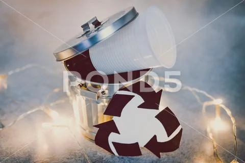 Disposable cups and garbage bin with recycle symbol, concept of reducing sing Stock Photos