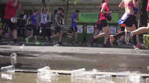 Disposable cups and water under the feet of running marathon runners Stock Footage 89830465