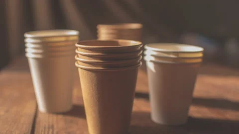 Disposable cups made of dark brown paper and white kraft paper Stock Footage 149750634