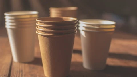 Disposable cups made of dark brown paper and white kraft paper Stock Footage 149750843
