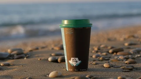 Disposable cups of tea or coffee against the background of the sea and the Stock Footage 121574351