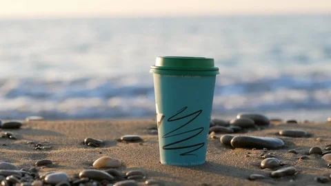 Disposable cups of tea or coffee against the background of the sea and the Stock-Footage 121574366
