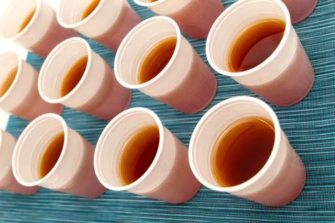 Disposable cups with tea. Stock Photos