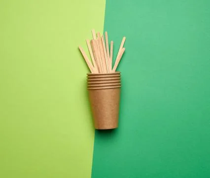 Disposable empty cups of brown craft paper and wooden sticks Stock Photos