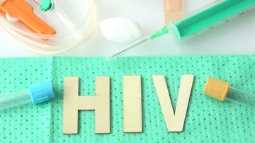 Disposable infusion set on green background. Inscription HIV. Stock Footage 85675760