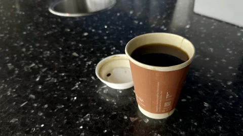Disposable Paper Coffee Cup with Lid on Table Stock Footage 346726481