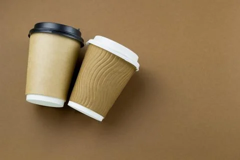 Disposable paper cups on a brown background Stock Photos