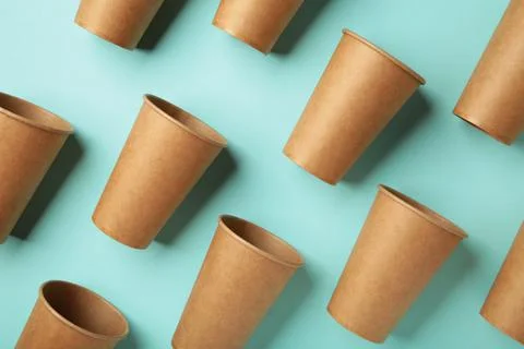 Disposable paper cups on mint background. Coffee concept. Stock Photos