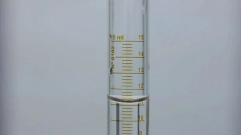 A disposable pipette tip take a fraction of a solution inside a graduated cilind Stock Footage 75845665