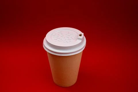 Disposable plastic cup on a red background Stock Photos