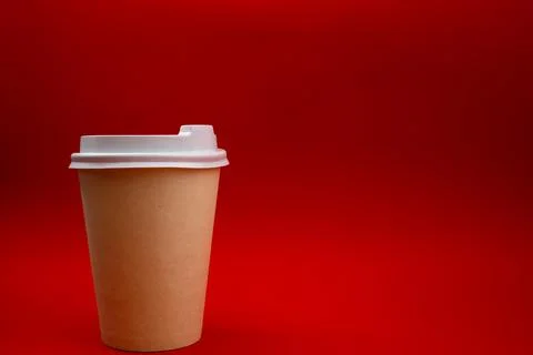Disposable plastic cup on a red background Stock Photos