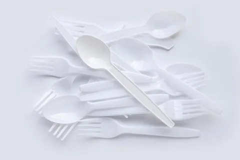 Disposable plastic spoon and fork. Plastic spoon and fork scattered  Stock Photos