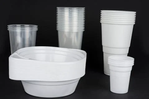 Disposable plastic ware on a black  background Stock Photos