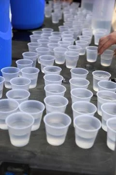 Disposable plastic water cups on table Foto stock