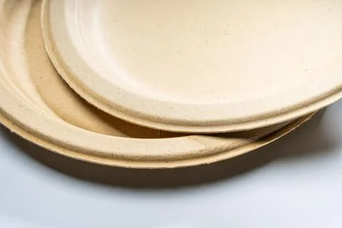 Disposable plates made of vegetable raw materials lie on the table Stock Photos