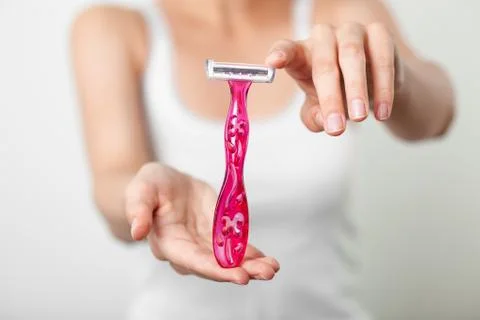 Disposable razor in hands Stock Photos