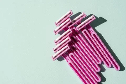 Disposable razors, a creative composition of disposable razors on a turquoise Stock Photos