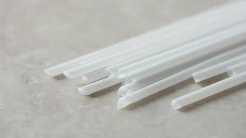 Disposable straws on marble background Stock Photos