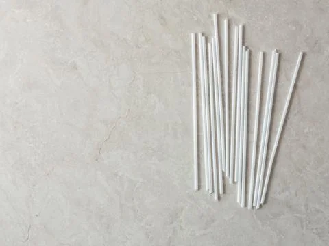 Disposable straws on marble background Stock Photos