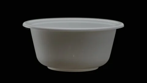 Disposable tableware, a bowl of ecological cornstarch on a black background Stock Footage 172545542