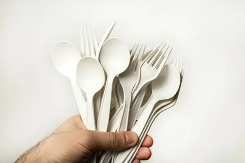 Disposable tableware from environmentally friendly materials in a hand Stock Photos