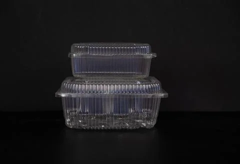 Disposable transparent plastic containers close-up on a black background Stock Photos