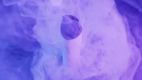 Disposable Vape Pen Rotating in Thick Smoke with Purple Light Video stock 325878240
