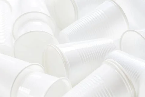 Disposable white plastic cups as background. Environmental concept. Non-co... Stock Photos
