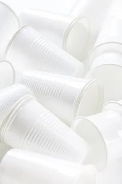 Disposable white plastic cups as background. Environmental concept. Non-co... Stock Photos