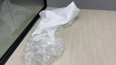 Disposable white plastic wrap on floor indoor pov shot. Video stock 253249262