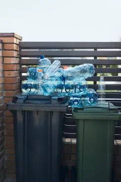 Disposal containers with empty used plastic water bottles on the top Stock Photos