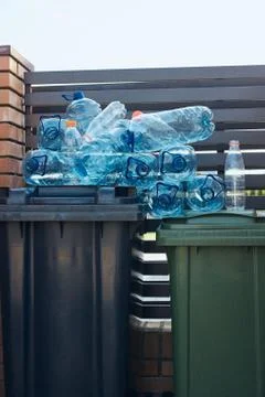 Disposal containers with empty used plastic water bottles on the top Stock Photos