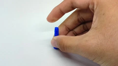 Dispose of the blood lancet needle by inserting it into the needle cap Stock Footage 294426160