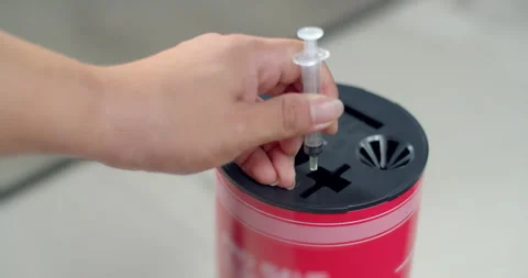Dispose of syringes in an infectious waste container.Remove the needle. Stock Footage 286313961
