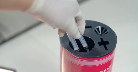 Dispose of syringes in an infectious waste container.Remove the needle. Stock Footage 294700875