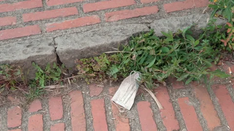 Disposed Face mask on the ground. Face mask on floor polluting environment Stock Footage 158510043