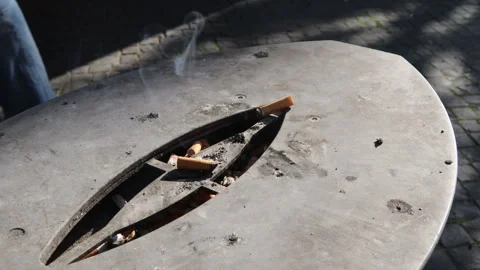 Disposing Cigarettes in Public Ashtrays Risks Contamination and Fire Hazards 스톡 동영상 245583514