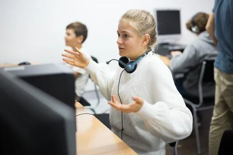 Dissapointed girl at computer table Stock Photos