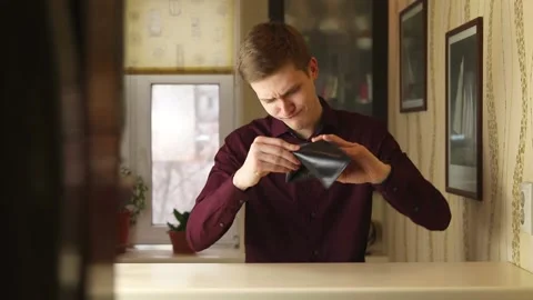 Dissapointed Young buisnessman checking empty wallet. Person looks into the Stock Footage 148188836