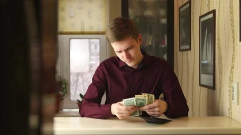 Dissapointed Young buisnessman checking wallet and counting money. Person looks Stock Footage 148188825