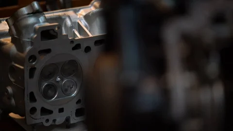 Dissassembled engine parts - 4 valve motorsport head in back of a shortblock Stock Footage 99276882